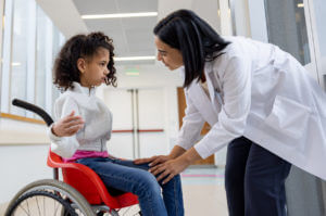 Doctor talking to a girl with cerebral palsy