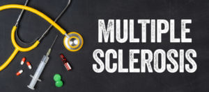A stethoscope and various pharmaceuticals are displayed on a blackboard with the phrase Multiple Sclerosis written on it.